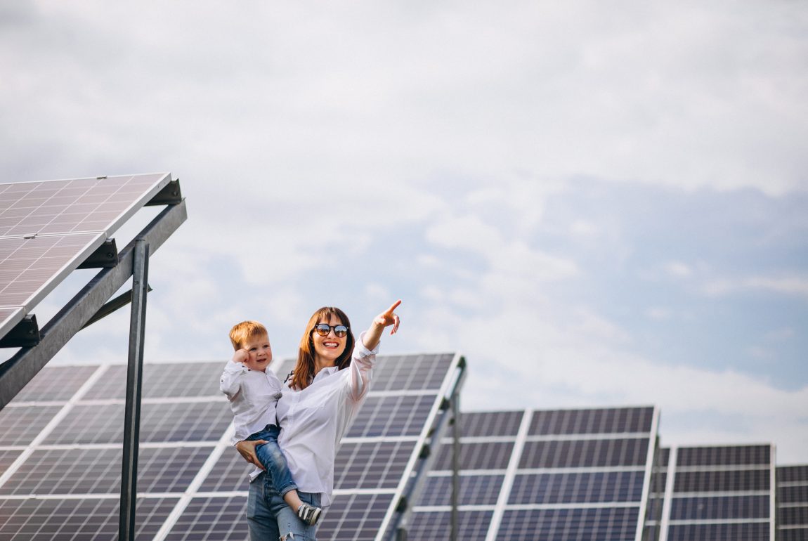 Mother with her little son by solar panels Mother with her little son by solar panels